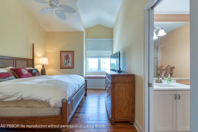 a bedroom with a bed and a mirror on dresser