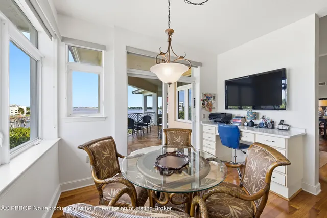 a dining room with furniture a flat screen tv and a chandelier