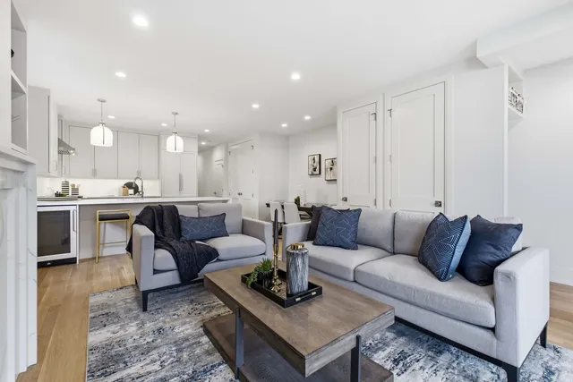 a living room with furniture kitchen view and a table