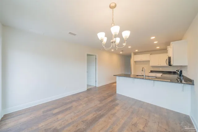 a view of a kitchen with a sink stainless steel appliances and cabinets
