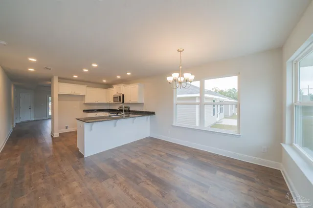 a view of kitchen with refrigerator and window