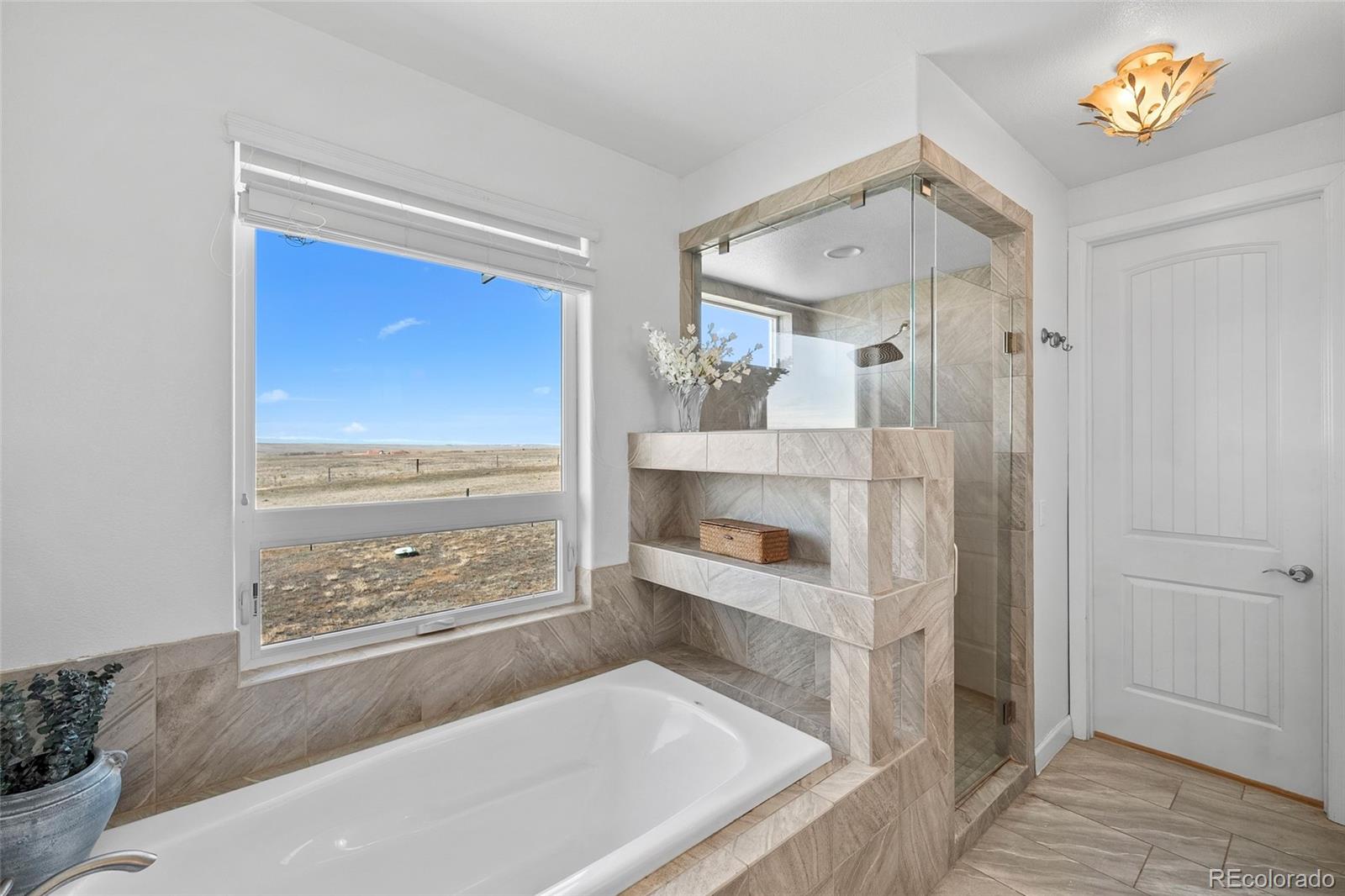 7600 Patrick Trail Elizabeth, CO 80107 - Photo 13 of 45 a bathroom with a tub and a view of bathroom