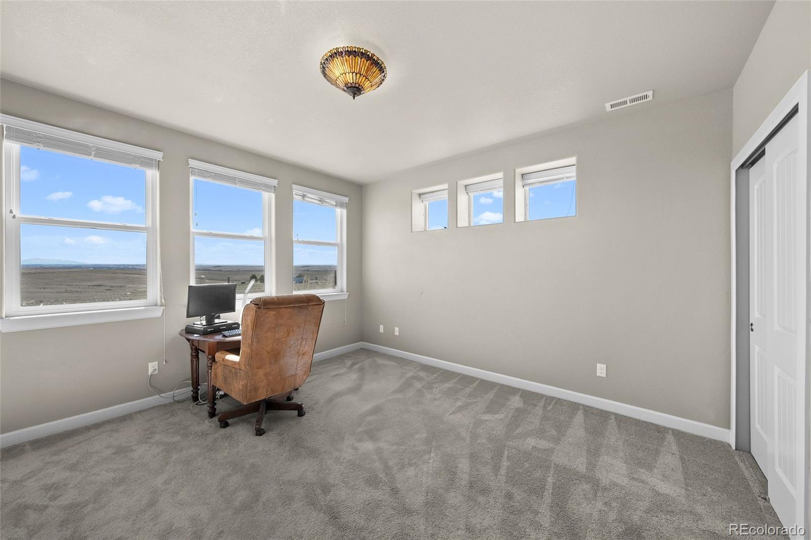 7600 Patrick Trail Elizabeth, CO 80107 - Photo 23 of 45 a room with chair and window