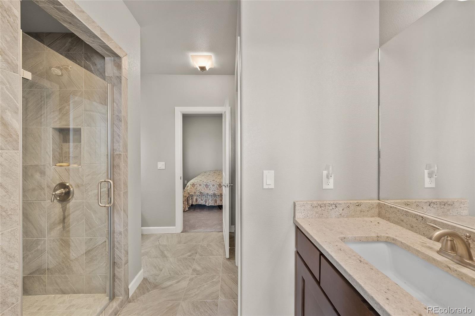 7600 Patrick Trail Elizabeth, CO 80107 - Photo 25 of 45 a bathroom with a granite countertop sink and a mirror
