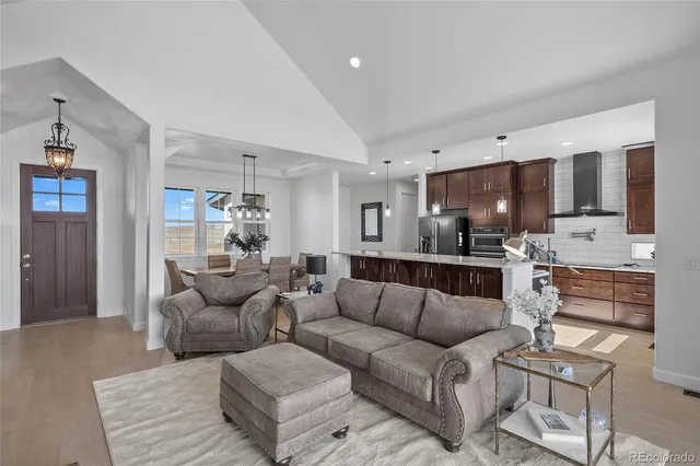 a view of kitchen with kitchen island stainless steel appliances sink refrigerator and microwave