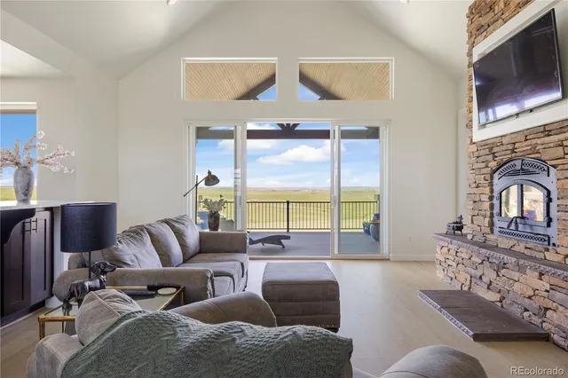 a living room with a fireplace and a flat screen tv