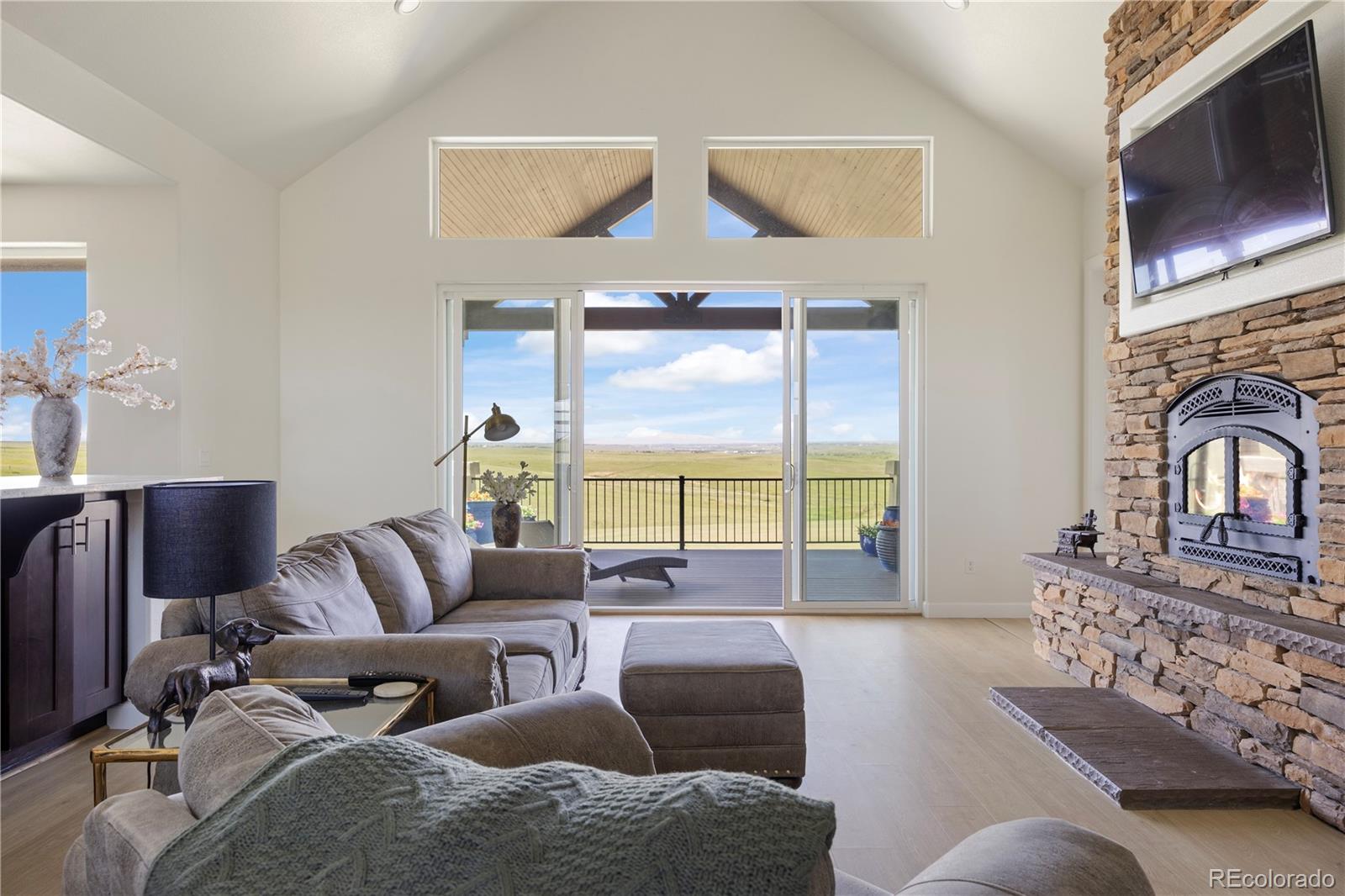 7600 Patrick Trail Elizabeth, CO 80107 - Photo 7 of 45 a living room with furniture fireplace and flat screen tv