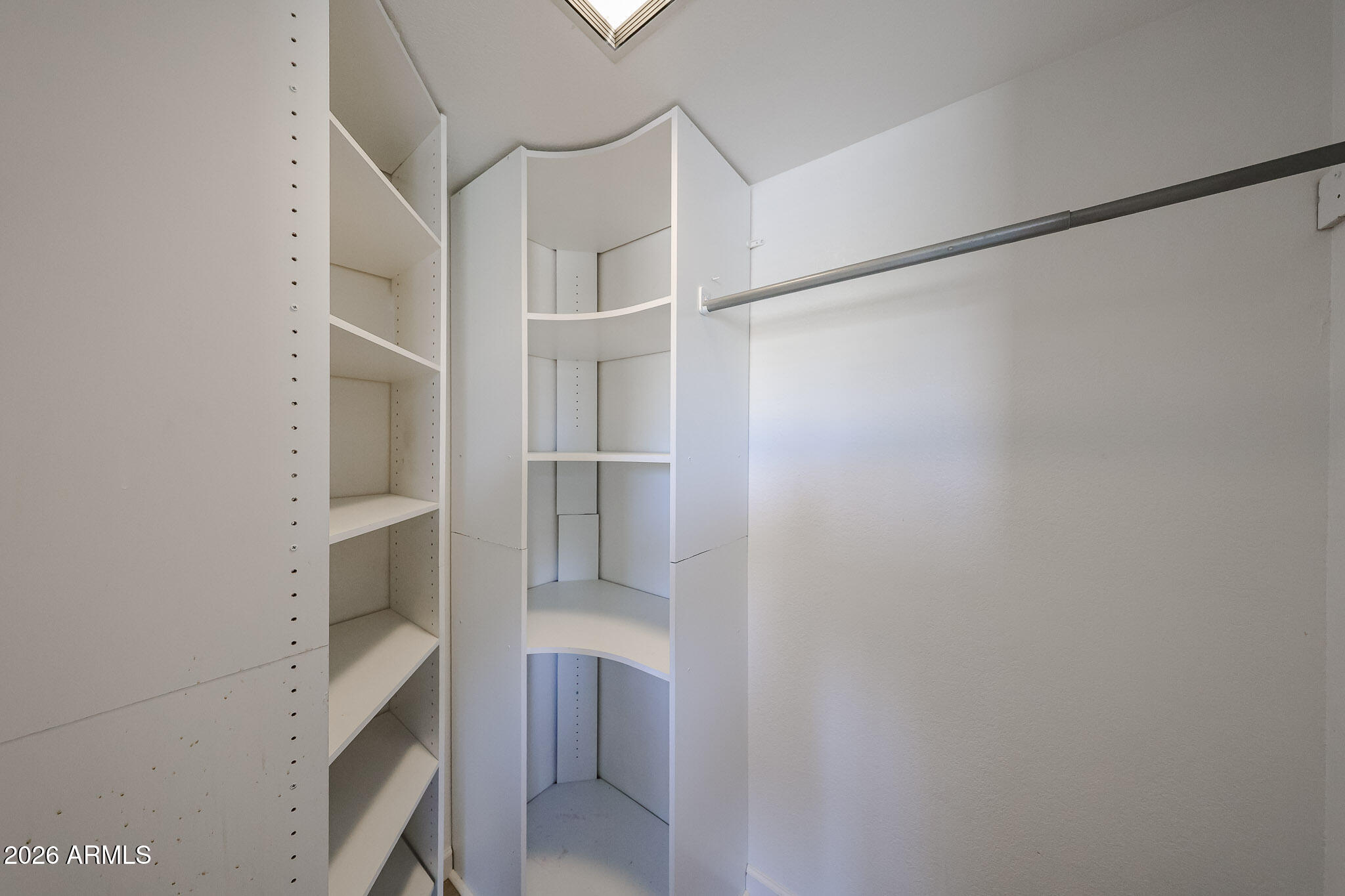 10410 North Cave Creek Road, Unit 1011 Phoenix, AZ 85020 - Photo 30 of 54 a view of walk in closet with empty racks