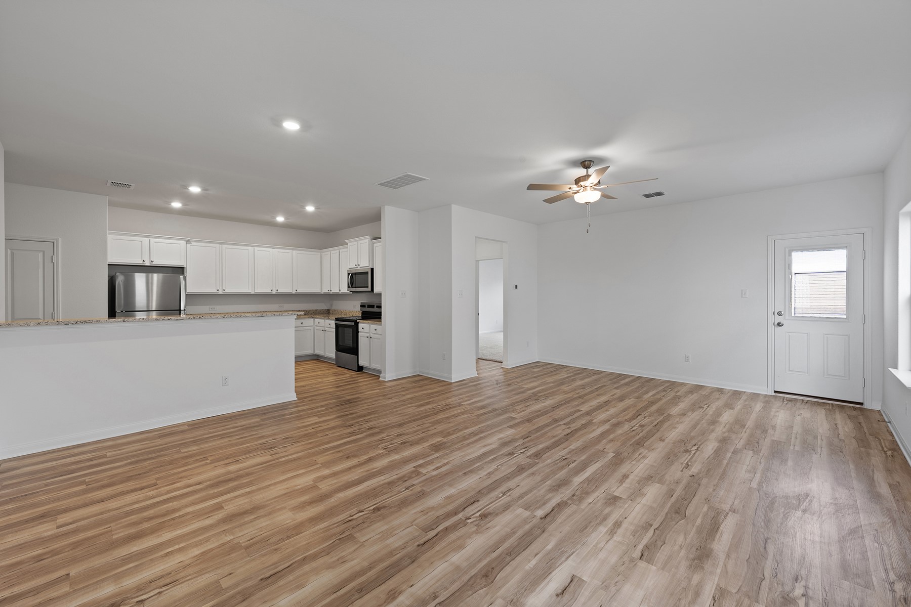 14401 Bonellis Pass Elgin, TX 78621 - Photo 2 of 13 a view of an empty room with a kitchen