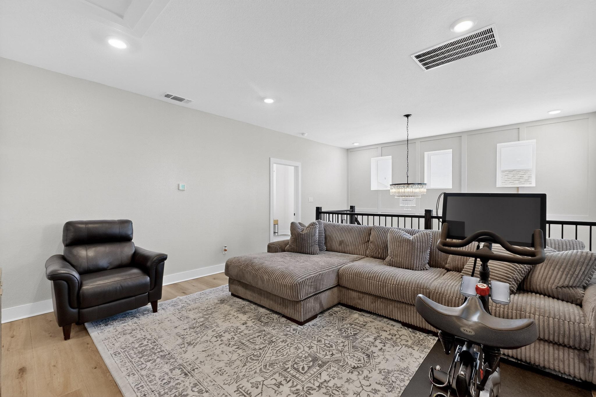 473 Bauer Loop Liberty Hill, TX 78642 - Photo 14 of 38 Living area with light wood-style floors, recessed lighting, and a chandelier
