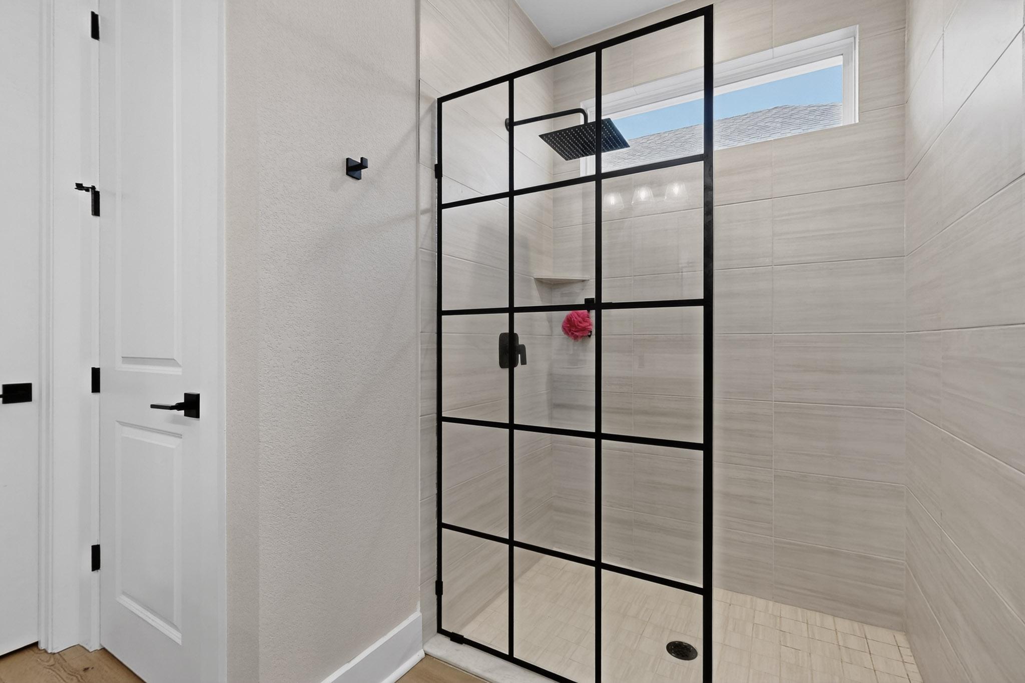 473 Bauer Loop Liberty Hill, TX 78642 - Photo 20 of 38 Full bathroom with a textured wall, walk in shower, and light wood-style floors