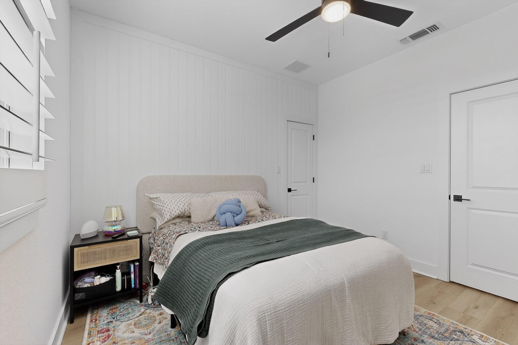 473 Bauer Loop Liberty Hill, TX 78642 - Photo 21 of 38 Bedroom #2 on upper level with light wood-style flooring and ceiling fan