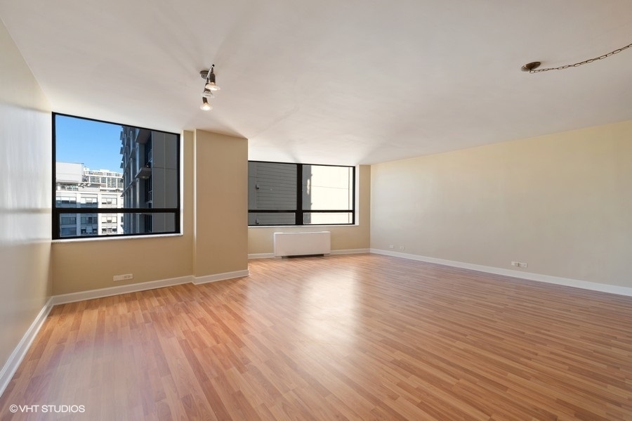 5701 North Sheridan Road, Unit 21H Chicago, IL 60660 - Photo 3 of 14 a view of empty room with wooden floor and fan