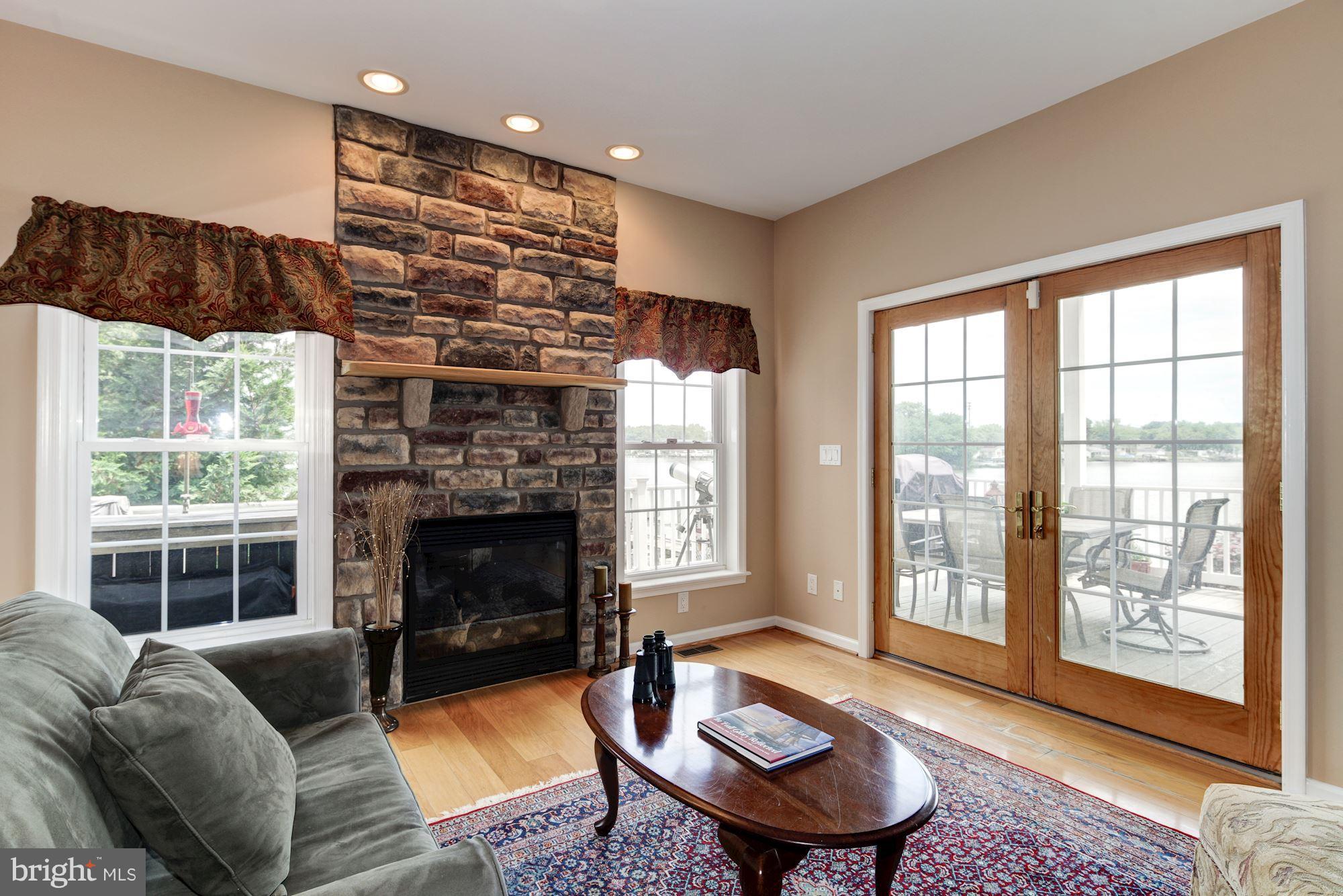 7230 River Drive Road Baltimore, MD 21219 - Photo 12 of 29 Living Room with Stone Fireplace