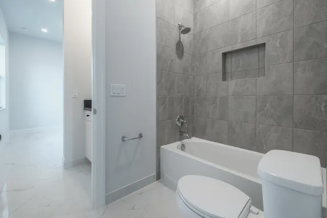a bathroom with a toilet and shower