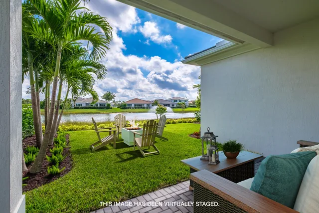 a view of a chair and table in patio with a garden