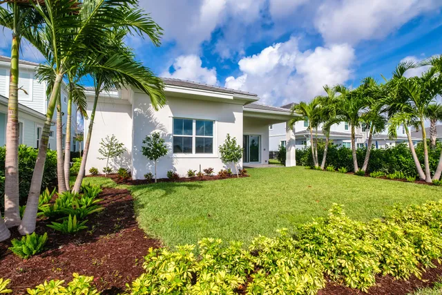 a view of a house with backyard and sitting area