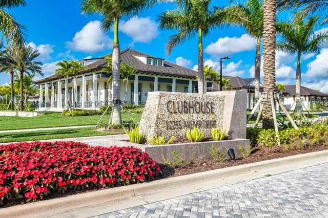 a view of a house with a yard and potted plants
