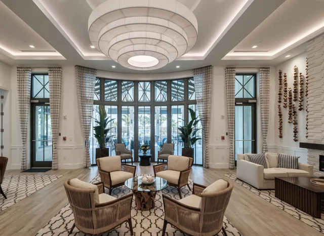 a living room with fireplace furniture and a large window