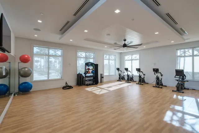 a view of a room with gym equipment and a large window