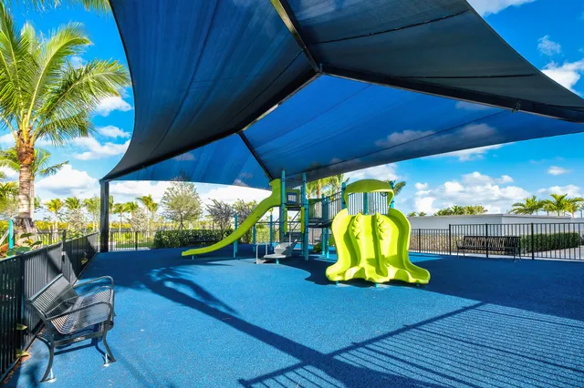 a view of a patio with a table chairs and a swimming pool