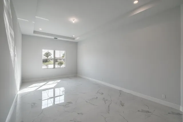 an empty room with windows and entrance