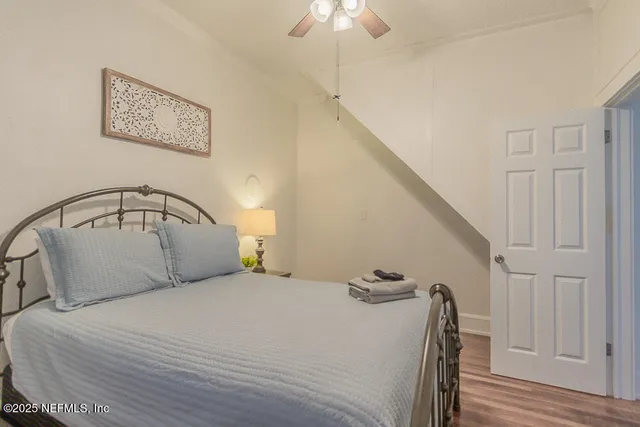 a bedroom with a bed and a chandelier