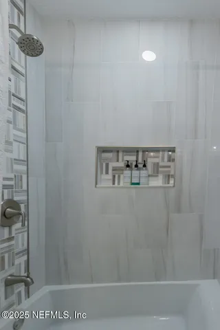 a view of entryway with wooden floor and windows