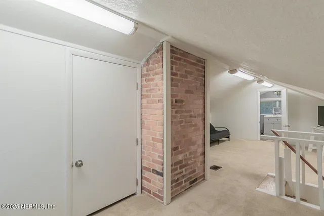 a living room with furniture and a air conditioner vent