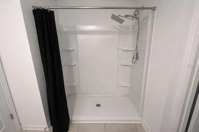 a bedroom with a bed and a lamp on desk