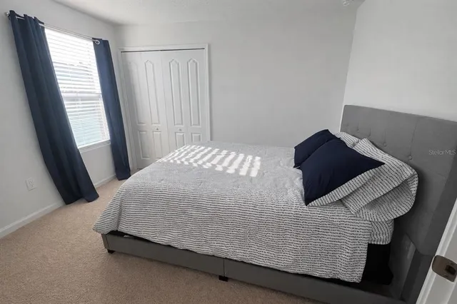 a bedroom with a bed and a window