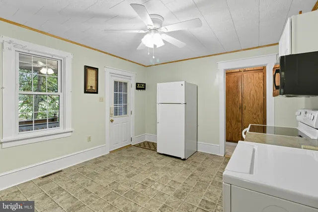 a view of kitchen with furniture and cabinets