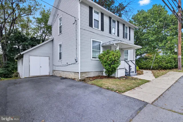 a view of a house with a yard and potted plants