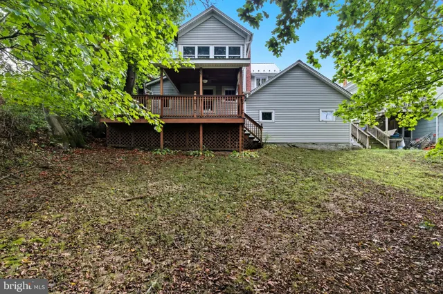 a view of house with backyard and garden