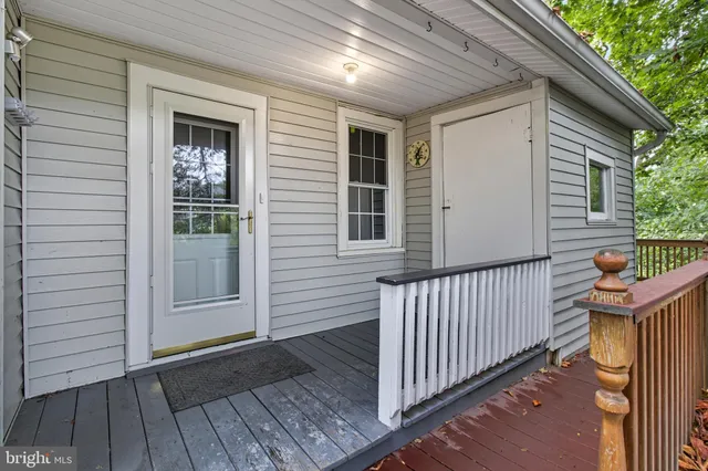 a view of a porch with wooden floor and stairs