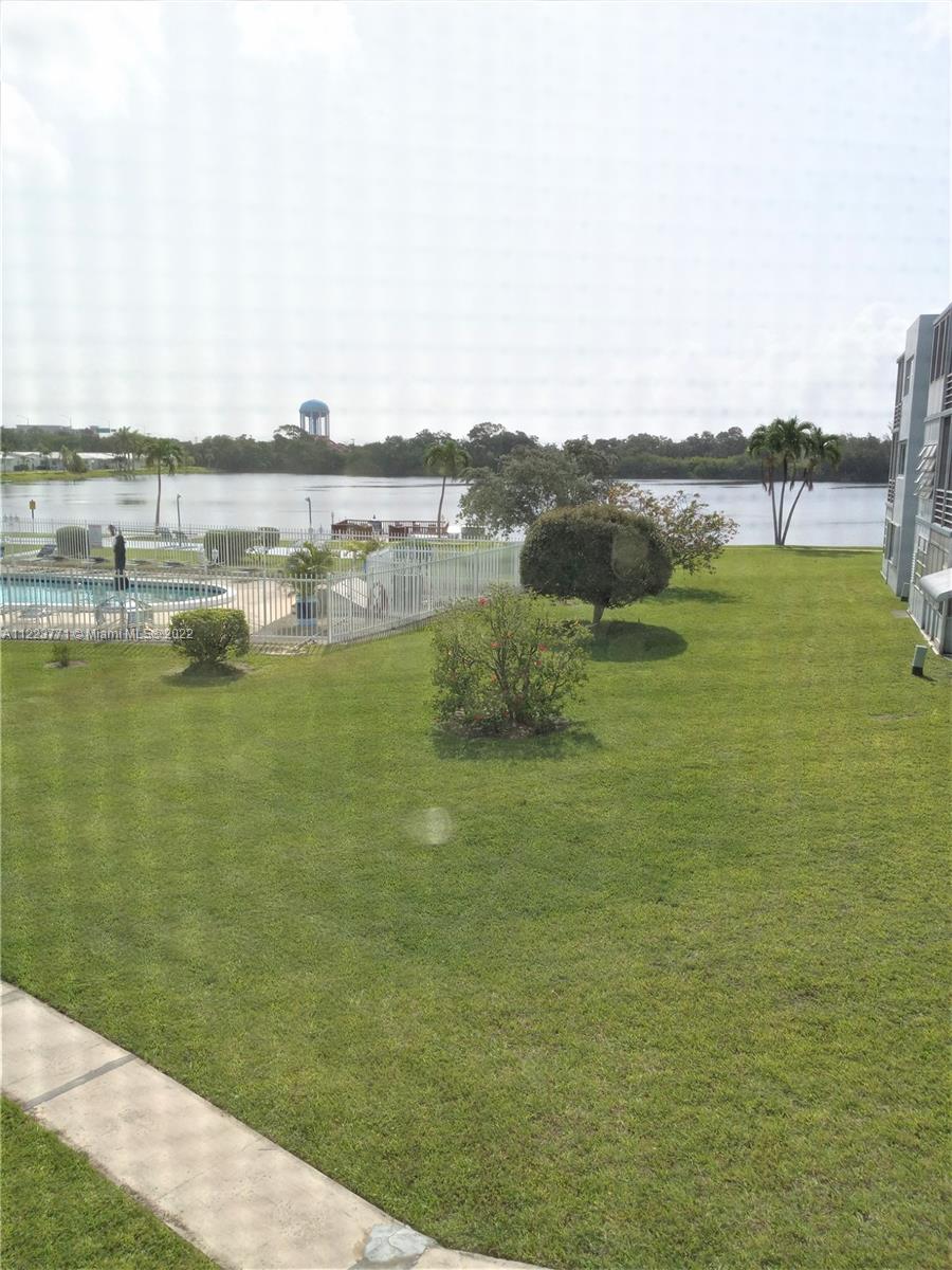 2223 Park Lane, Unit 211 Hollywood, FL 33021 - Photo 15 of 21 a view of a lake with houses in the back