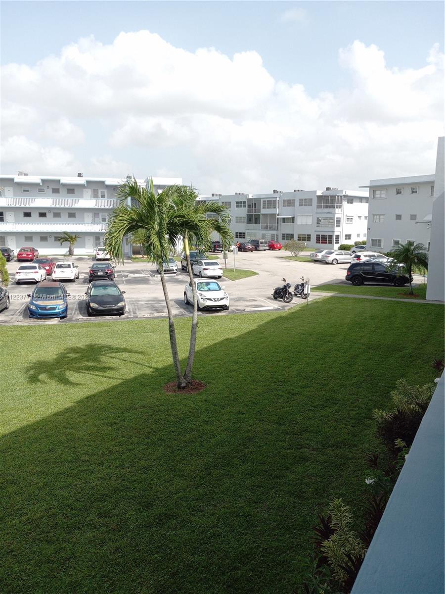 2223 Park Lane, Unit 211 Hollywood, FL 33021 - Photo 17 of 21 a view of a swimming pool and a yard