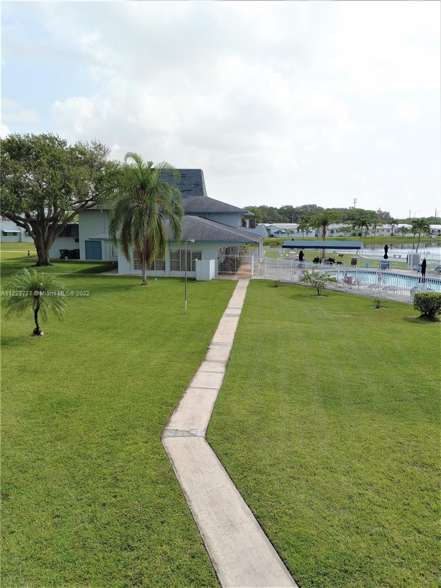 2223 Park Lane, Unit 211 Hollywood, FL 33021 - Photo 18 of 21 a view of a lake with a yard