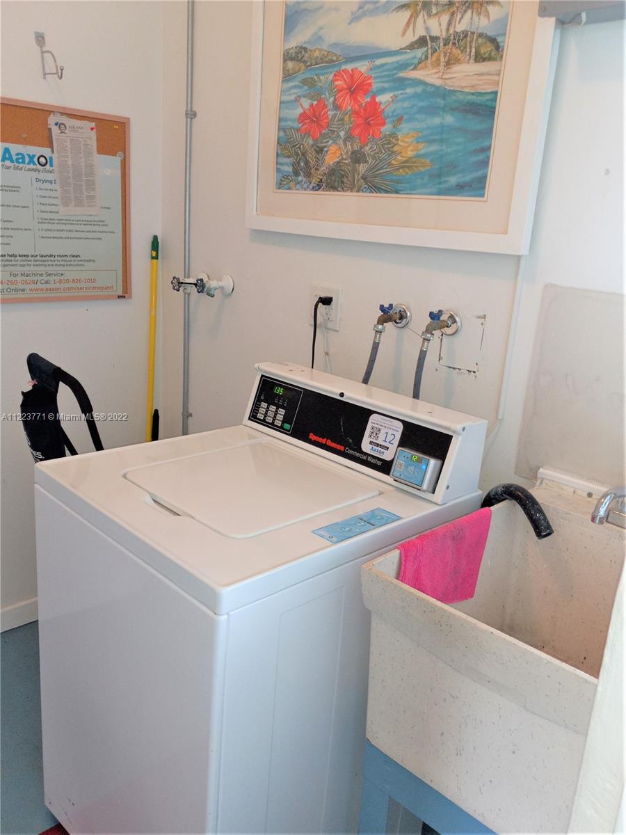 2223 Park Lane, Unit 211 Hollywood, FL 33021 - Photo 20 of 21 a bedroom with a bed and cabinets