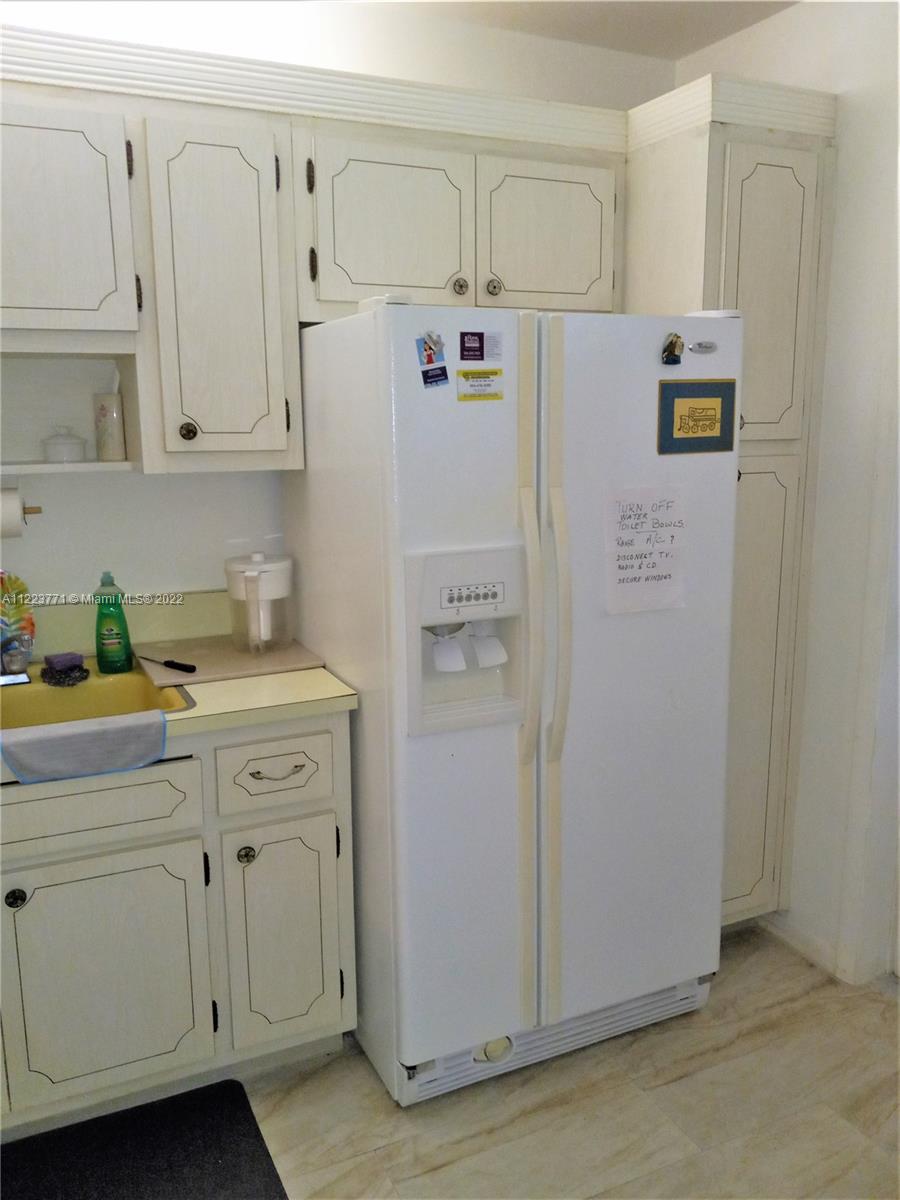 2223 Park Lane, Unit 211 Hollywood, FL 33021 - Photo 6 of 21 a white refrigerator freezer sitting inside of a kitchen