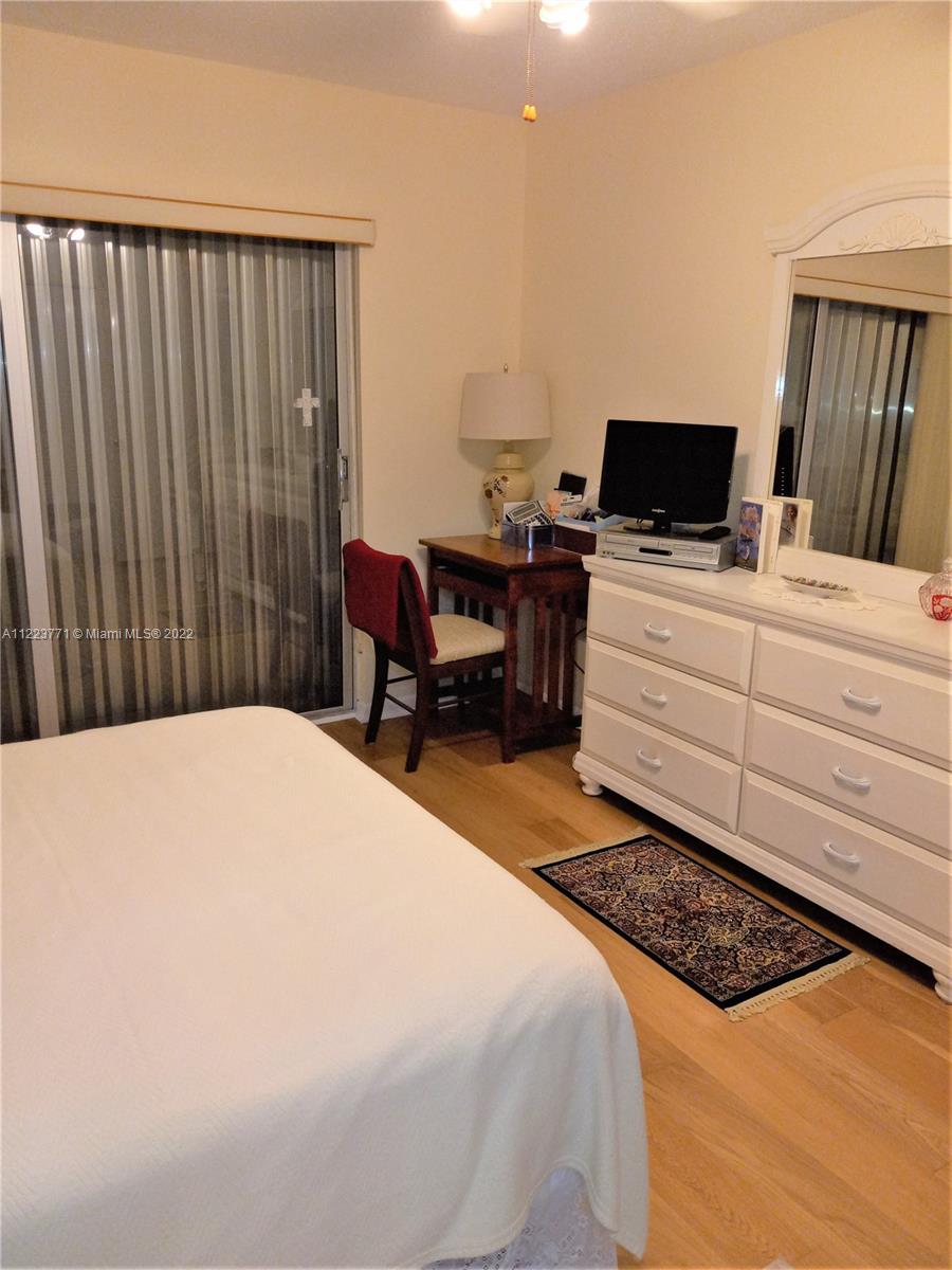 2223 Park Lane, Unit 211 Hollywood, FL 33021 - Photo 9 of 21 a bedroom with a bed and a television