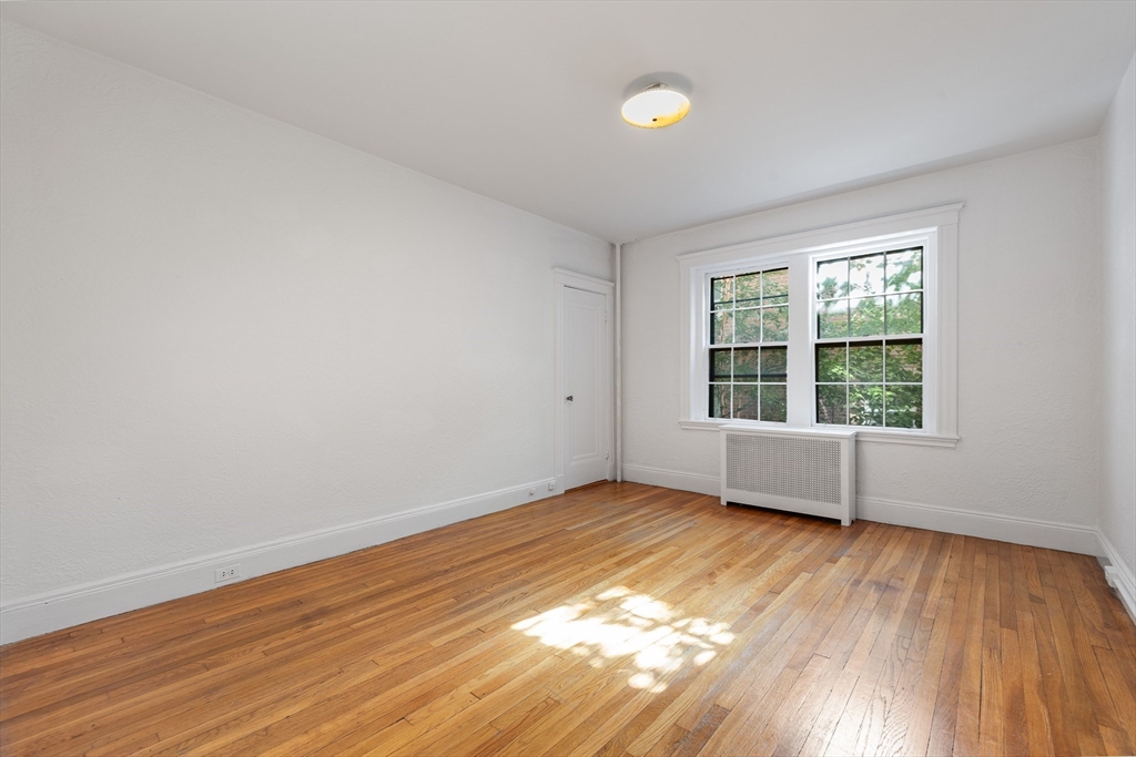15-17 James Street, Unit 2 Brookline, MA 02446 - Photo 19 of 28 a view of an empty room with wooden floor and a window