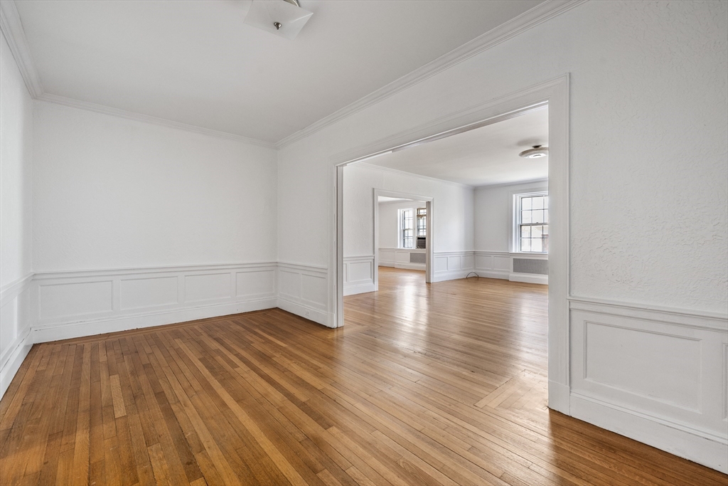 15-17 James Street, Unit 2 Brookline, MA 02446 - Photo 3 of 28 a view of a room with wooden floors and kitchen view