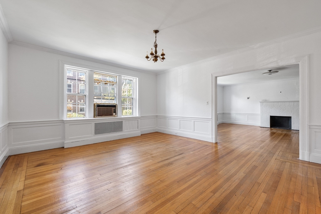 15-17 James Street, Unit 2 Brookline, MA 02446 - Photo 8 of 28 a view of empty room with wooden floor and fireplace