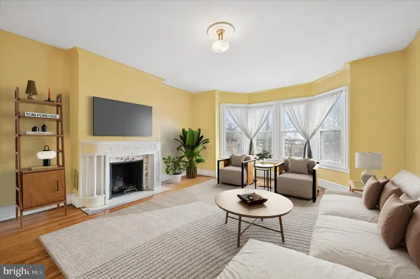 a living room with furniture a rug and a fireplace