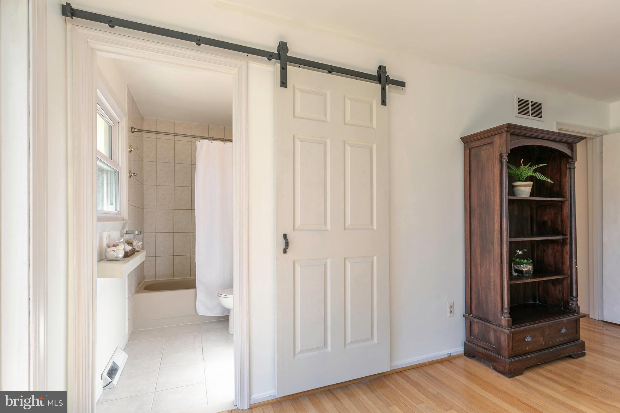 108 Rutledge Road Queenstown, MD 21658 - Photo 26 of 37 Modern fun barn door for primary bathroom entry