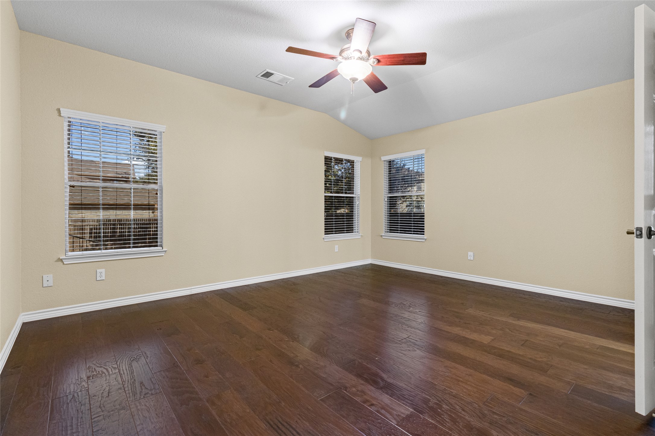 14901 Staked Plains Loop Austin, TX 78717 - Photo 14 of 30 Master bedroom featuring wood flooring, lofted ceiling, and a ceiling fan