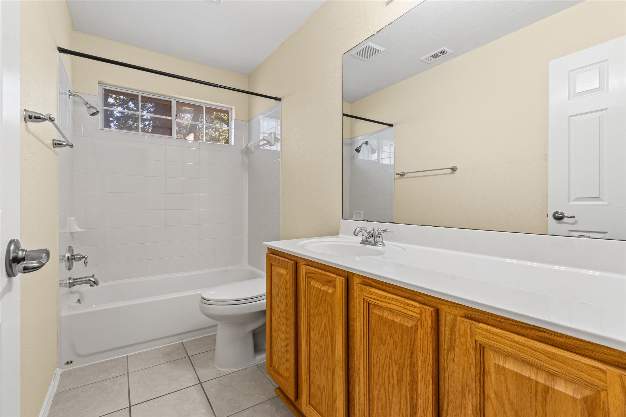 14901 Staked Plains Loop Austin, TX 78717 - Photo 22 of 30 Bathroom with vanity, shower / washtub combination, and light tile patterned floors