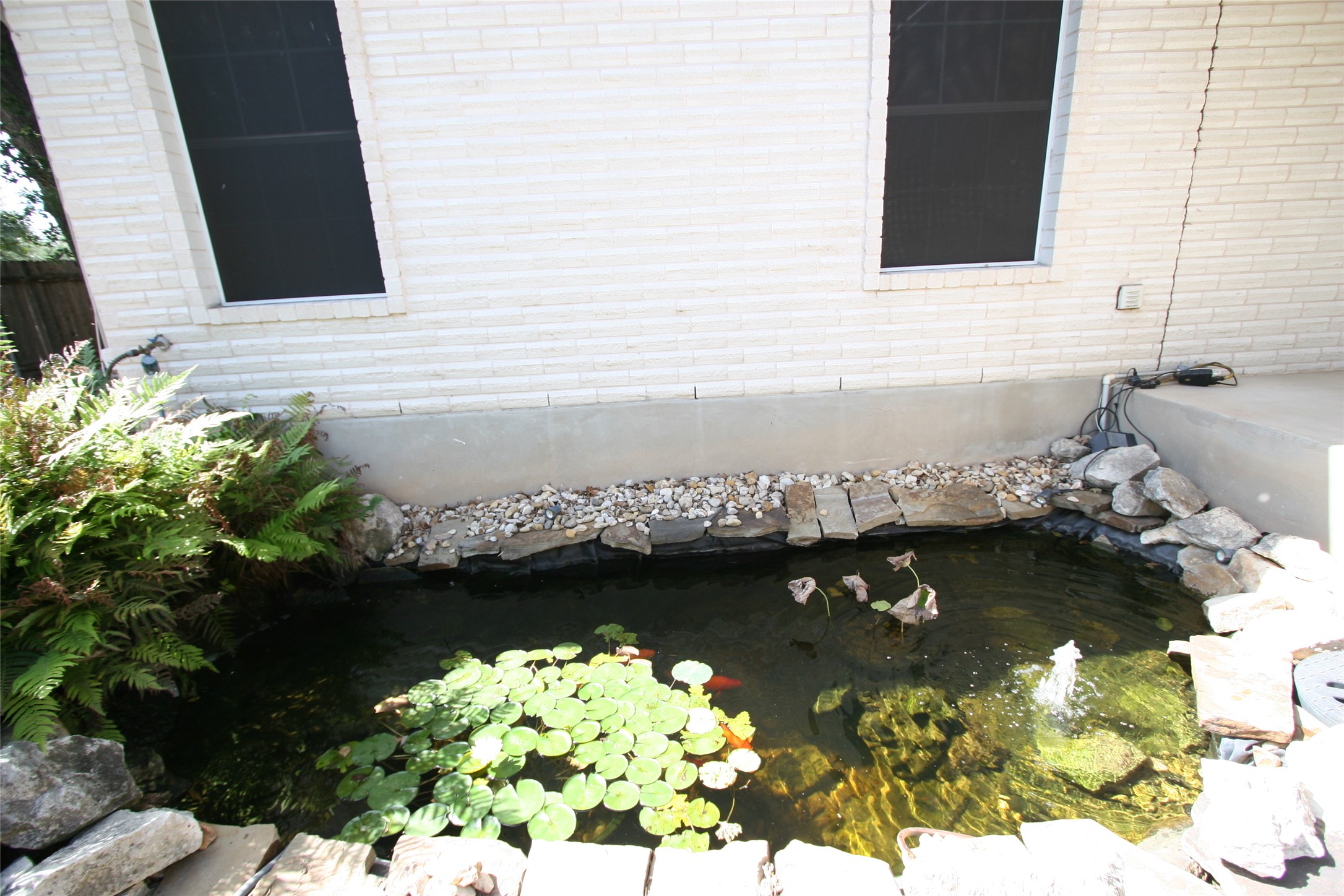 14901 Staked Plains Loop Austin, TX 78717 - Photo 23 of 30 Koi pond with water fall feature