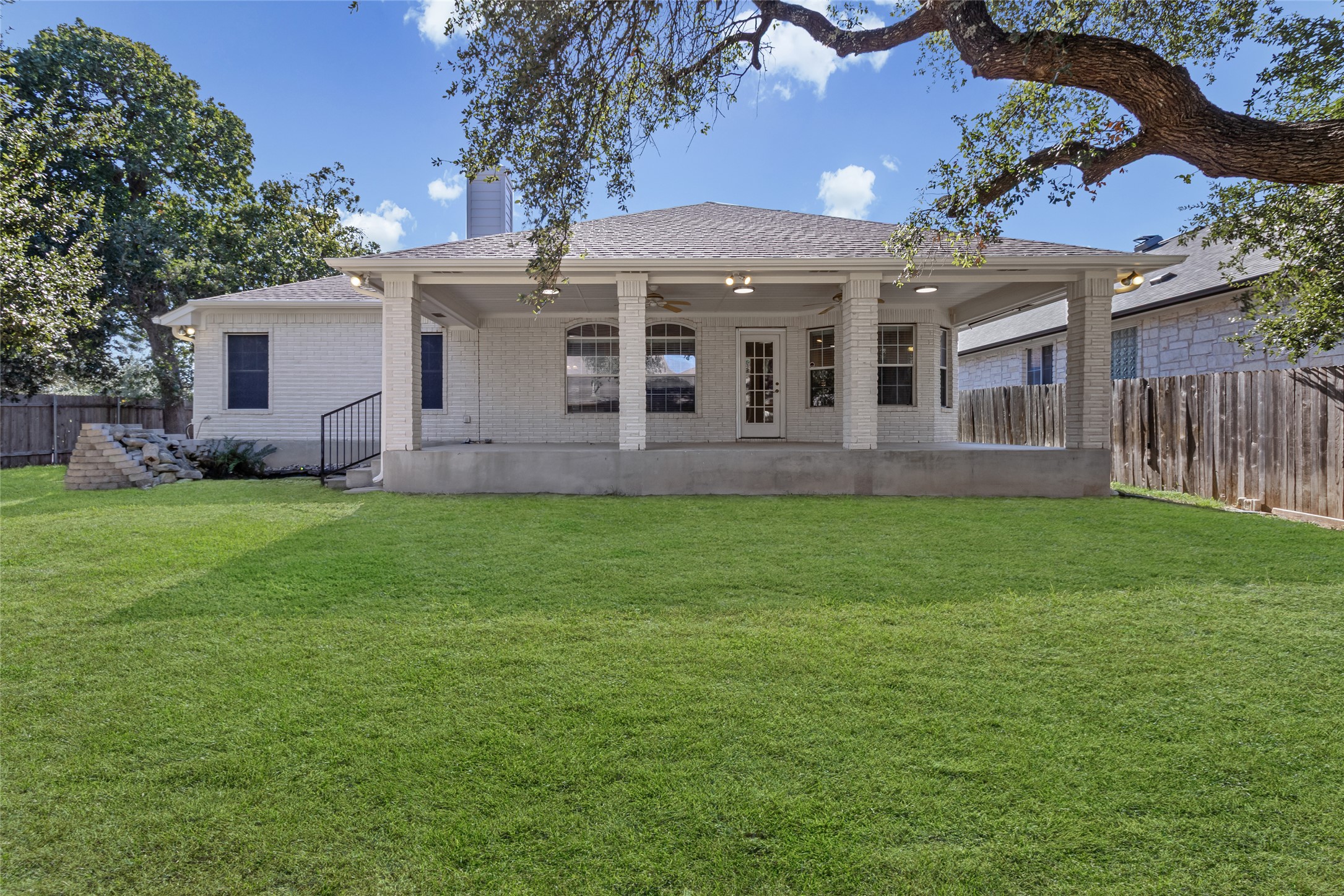 14901 Staked Plains Loop Austin, TX 78717 - Photo 27 of 30 Rear view of house featuring brick siding, a patio, a ceiling fan, and a chimney